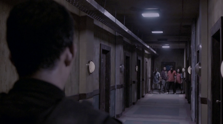 Long, over-the-shoulder hallway shot, from The Raid: Redemption.
